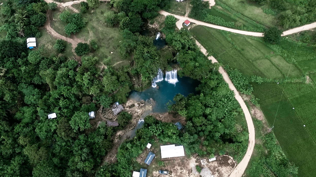 drone shot of bolinao falls and farmlands in pangasinan province philippines